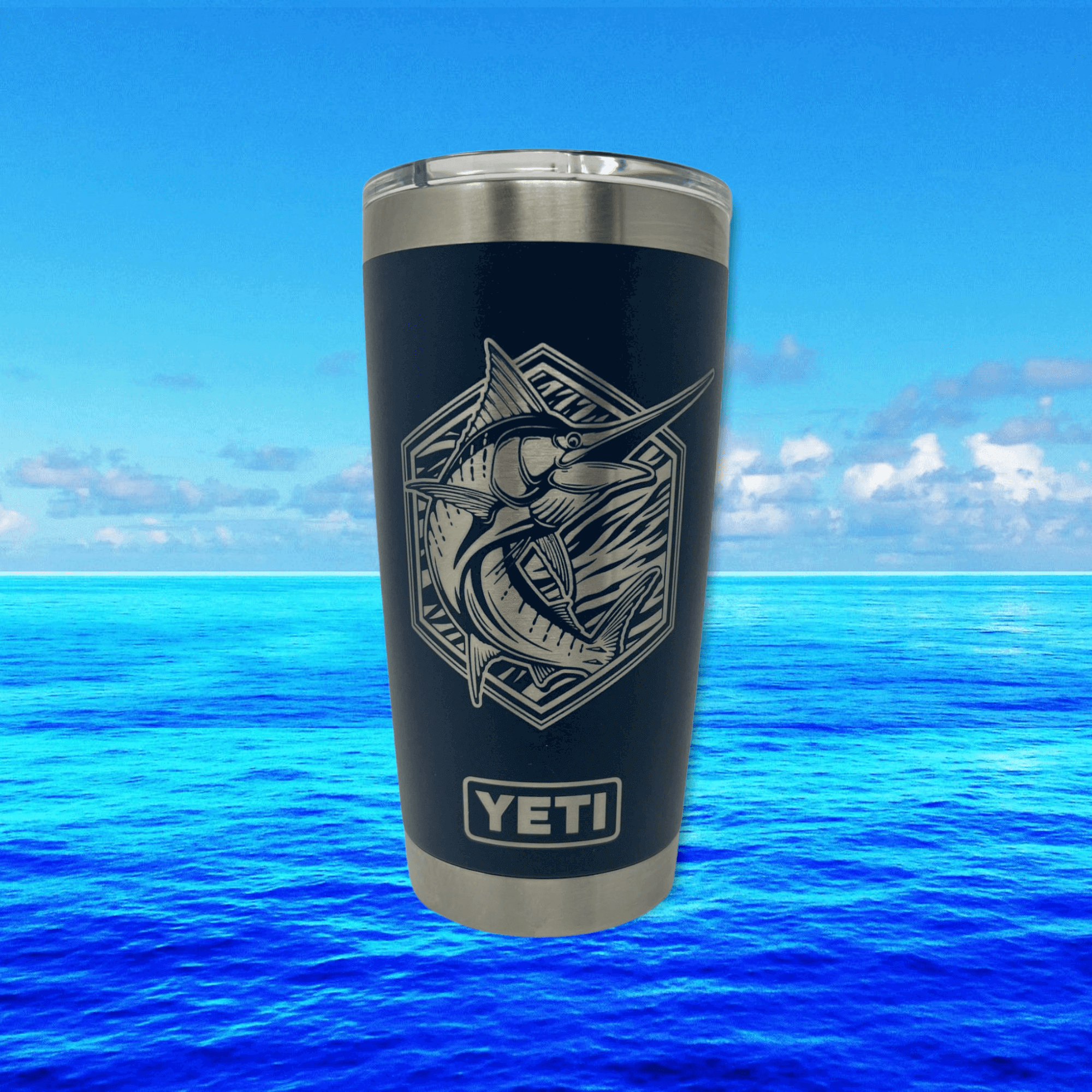 Marlin offshore fishing artwork by Joel Jensen Art laser engraved - silver on black Yeti tumbler with ocean water background.  Wind River Outpost