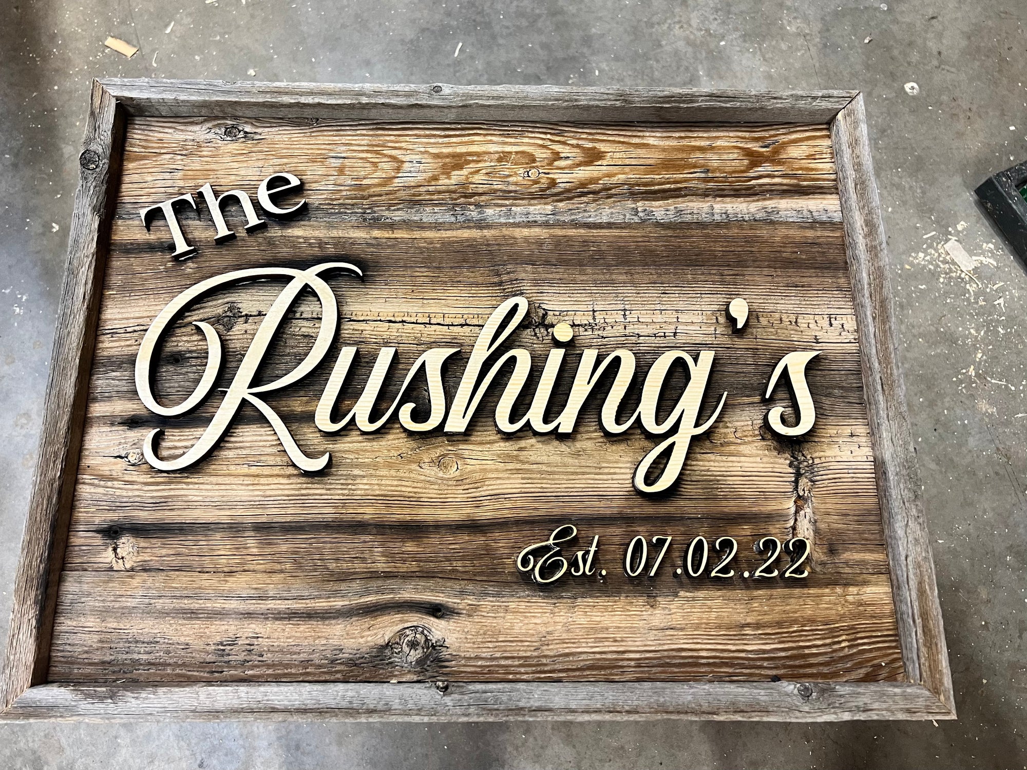 Alternate view of rustic 19x25 inch wedding sign showing last name, made of rustic barn wood with offset inlaid lettering. Custom made to order.