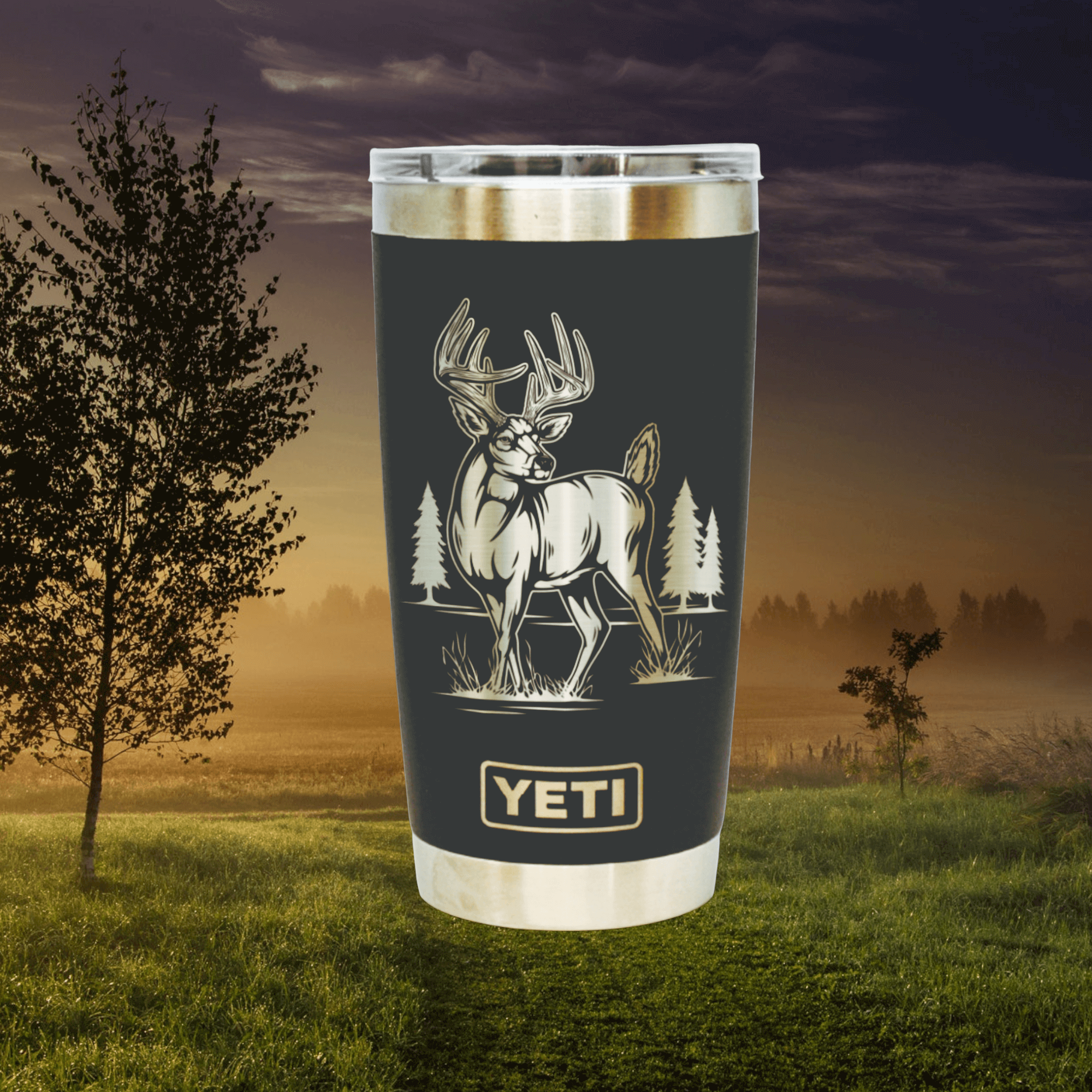 Black Yeti rambler with whitetail deer. Outdoor scene in background of photo.